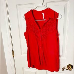 Hot pink collared sleeveless button down with lace detailing along the shoulders
